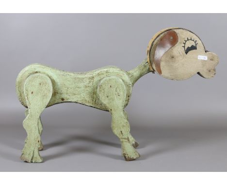 A vintage painted wooden toy dog with leather ears. 