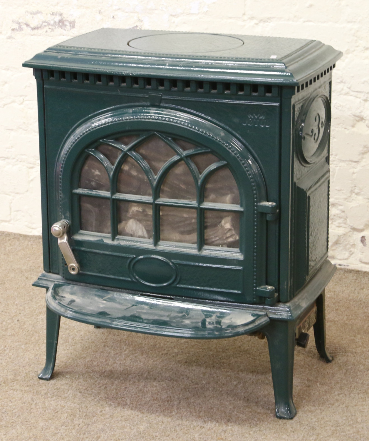 A Jotul Green enamel gas powered stove.