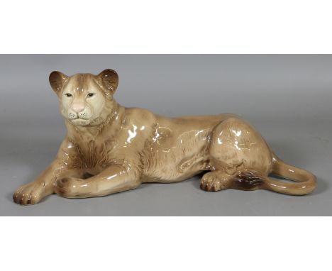 A Melba ware model of a recumbant lioness.