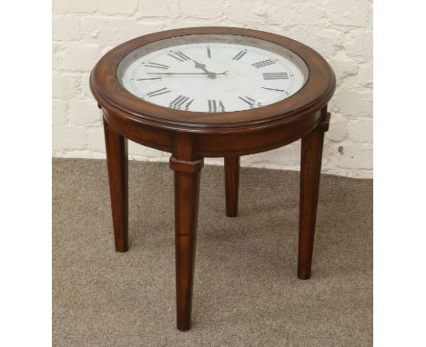 A mahogany circular occasional glass top table with inset working clock dial.