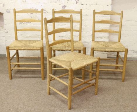 A set of four light oak ladder back kitchen chairs with seagrass seats. 