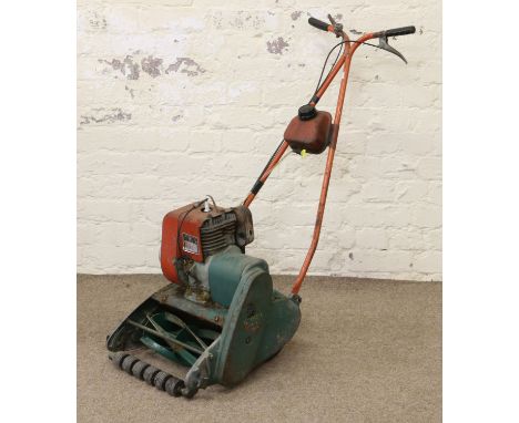 A Suffolk Super petrol lawnmower with roller and grass box.
