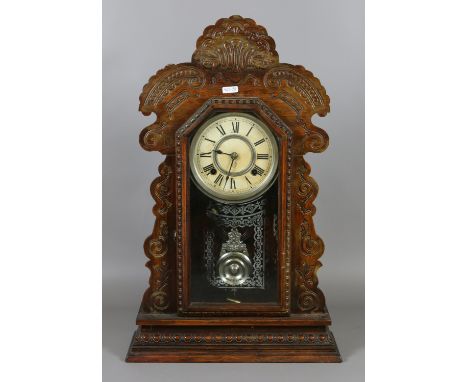 An American carved ginger bread mantel clock with chrome dial and pendulum chiming hourly and half-hourly on a coiled gong co