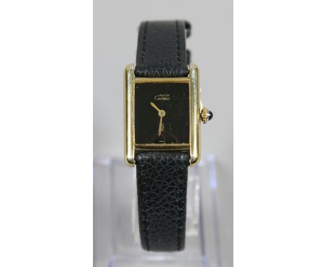 A ladies cased  Must de Cartier manual silver gilt wristwatch with cabachon sapphire crown.