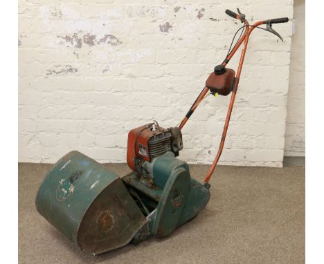 A Suffolk Super Punch petrol lawn mower with roller and grass box.