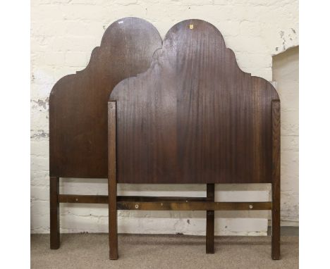 A pair of carved oak single bed headboards.