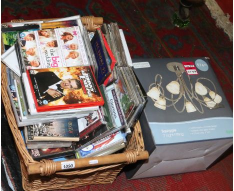 A basket and contents of assorted DVDs and compact discs along with a boxed light fitting.