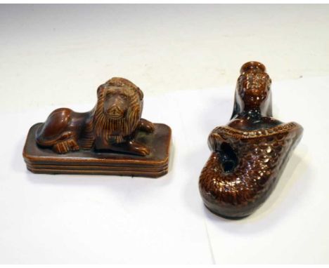 19th Century treacle-glazed pottery lion flask (15cm long), together with a mermaid flask (19.5cm high) (2)