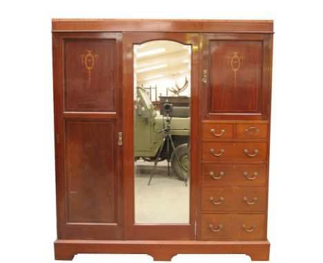 An Edwardian inlaid mahogany Compactum wardrobe
Requires restoration with a plain frieze with a cavetto cornice, incomplete a