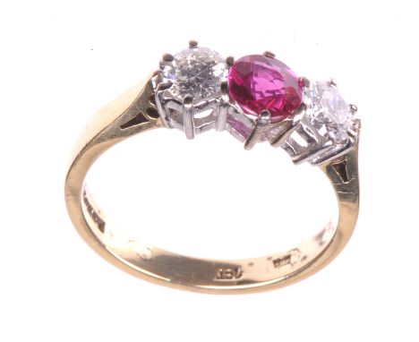 A ruby and diamond set three stone ring
The central round cut ruby of an estimated 0.58cts flanked by two round brilliant cut