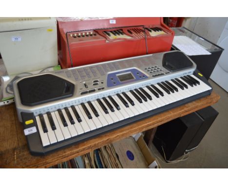 A Casio keyboard with instruction manual