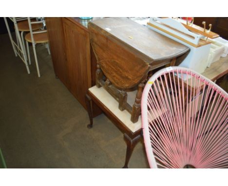 An oak drop leaf gate leg table; together with a mahogany stool raised on cabriole supports