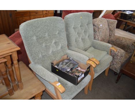 A pair of green upholstered button down armchairs