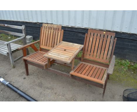 A teak garden bench with integral table 