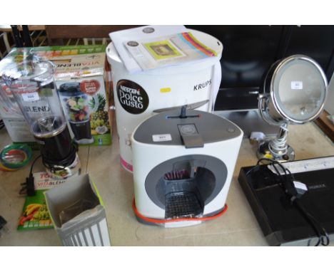 A Dolce gusto coffee maker with original box and instruction manual