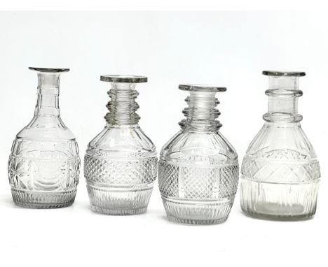 Four Early 19th Century Georgian glass carafe decanters. 19cm. 18cm.