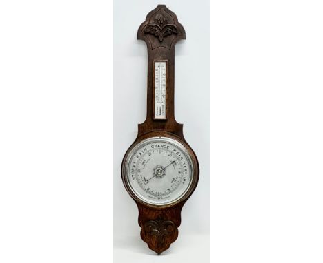 An Edwardian period oak barometer. 81cm
