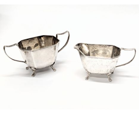 A silver cream jug with matching sugar pot by Harrison Fisher &amp; Co. Sheffield, 1947. Total weight 412g.