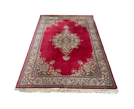 A large Persian style rug. 240x355cm