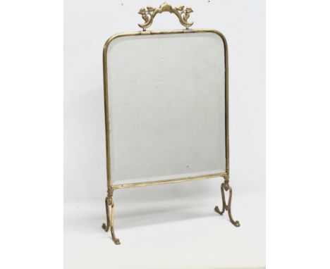 An Edwardian brass framed firescreen. 44x75cm