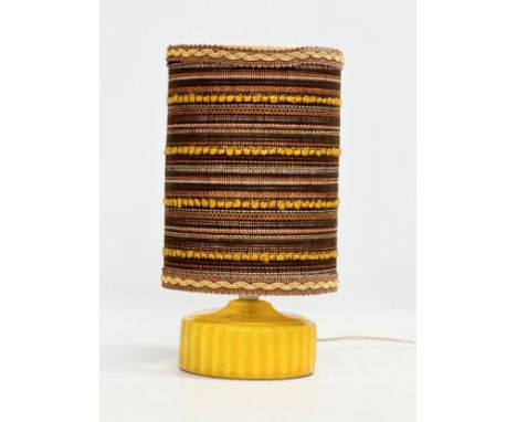 A 1970’s Mid Century yellow glazed pottery table lamp with original shade. 27cm