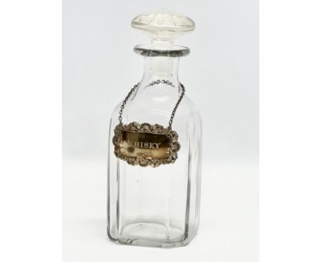 Silver label. An Early 20th Century glass decanter with silver whisky label. 21.5cm