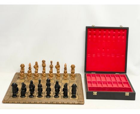 A large Egyptian style wooden chess set with case. Board measures 60x60cm