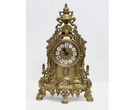 An 18th Century style brass mantle clock. 24x42cm