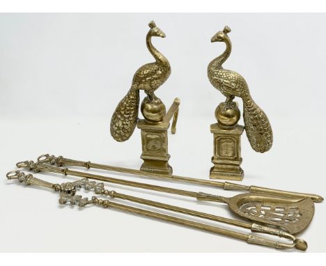A pair of large 20th Century peacock brass fire andirons and tools.
