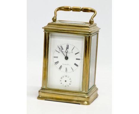 Howell James &amp; Co. A Late 19th Century brass carriage clock with 5 bevelled glass panels and key. 9x8x14cm