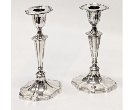A pair of Early 20th Century silver candlesticks by Hawksworth, Eyre &amp; Co Ltd. Sheffield, 1907. 18.5cm. (filled).