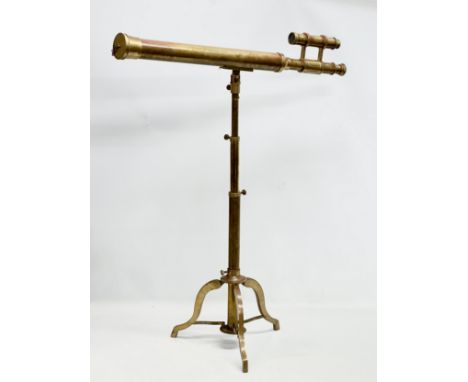 A brass adjustable tripod telescope. 137cm