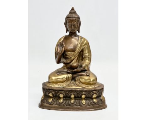 A Late 19th/Early 20th Century brass seated Buddha statue. 20cm