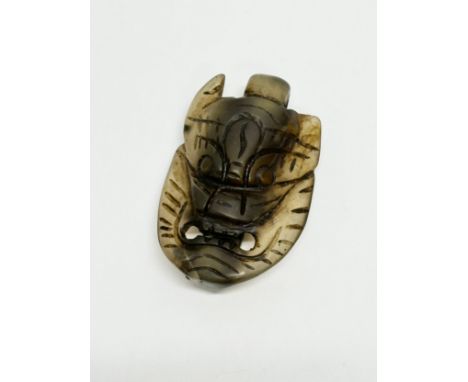 A Chinese Late Ming/Early Qing Dynasty carved jade pendant. 6.5cm