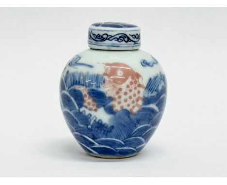 A small 19th Century Chinese Qing Dynasty koi fish jar with cover. Kangxi mark. 7cm
