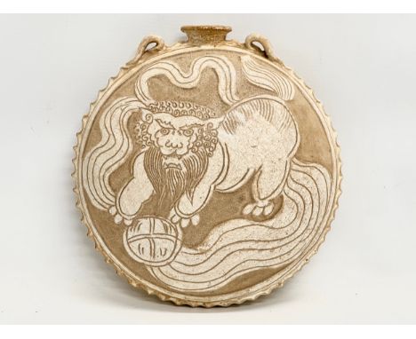 A Song Dynasty (970-1279) Chinese Cizhou flask. A decorated stoneware vessel with glazed Foo Lion and lotus petals. 24x25cm.