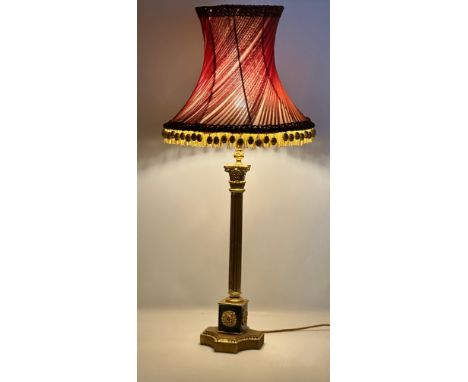 A good quality Mid 20th Century gilt brass table lamp with Corinthian style column, raised on a gilt wooden base. 95cm