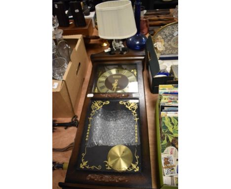 A President Quartz wall clock with pendulum and a modern glass bedside table lamp.