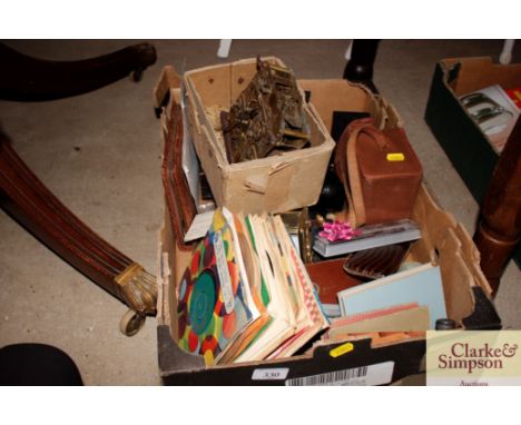 A box containing various items to include carriage clock, pens, boxed Brownie camera, various records etc.