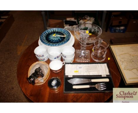 A dachshund ornament together with a quantity of ramekins, glass candlestick, fish servers etc.