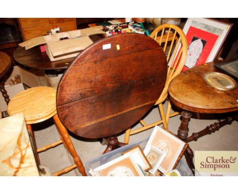 A 19th Century tilt top table raised on tripod base 