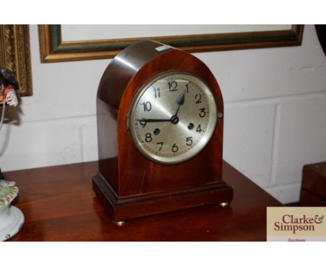 A two hole mahogany cased mantel clock with chequer banded inlay