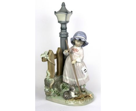 A large Lladro figurine of a girl beside a lamp post, H. 33cm.