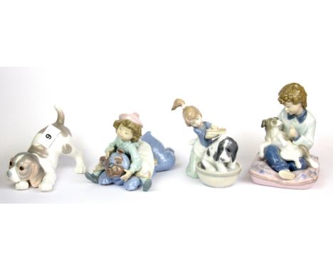 Four Lladro figures of children and puppies, tallest 15cm.