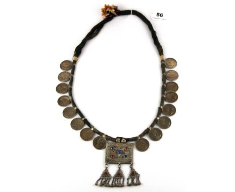 An interesting Gurkha officer's ceremonial 'necklace' of colonial coins and stone set white metal panel, folded L. 55cm.