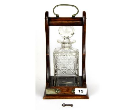 A single bottle oak tantalus with cut glass decanter, H. 30cm.