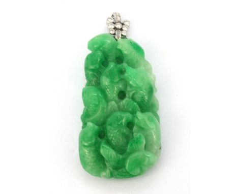 A large carved jade pendant on a white metal (tested 18ct gold) bail set with brilliant and baguette cut diamonds, L. 8.5cm, 
