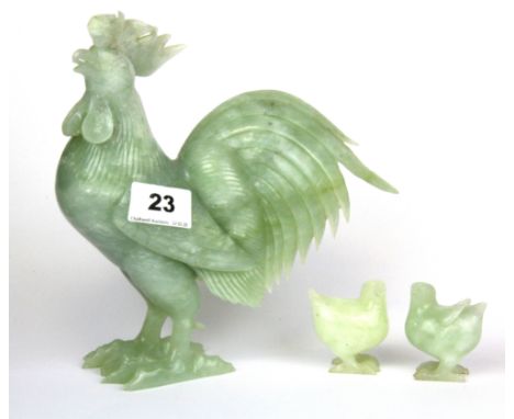 A Chinese carved jade/ hardstone figure of a cockerel with two chicks, H. 20cm.