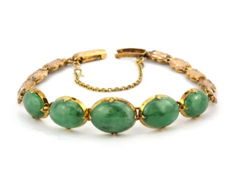 A yellow metal (tested minimum 9ct gold) bracelet set with graduated cabochon cut jadeite jade, with GCS certificate, Dia. 5.
