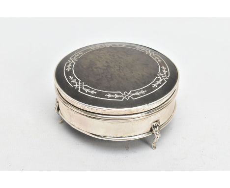 A SILVER AND TORTOISESHELL BOX, of a circular form, plain polished body raised on three scroll feet, fitted with a hinged tor